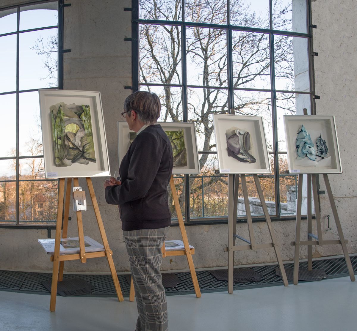 Prue Bishop views her completed artworks in a gallery