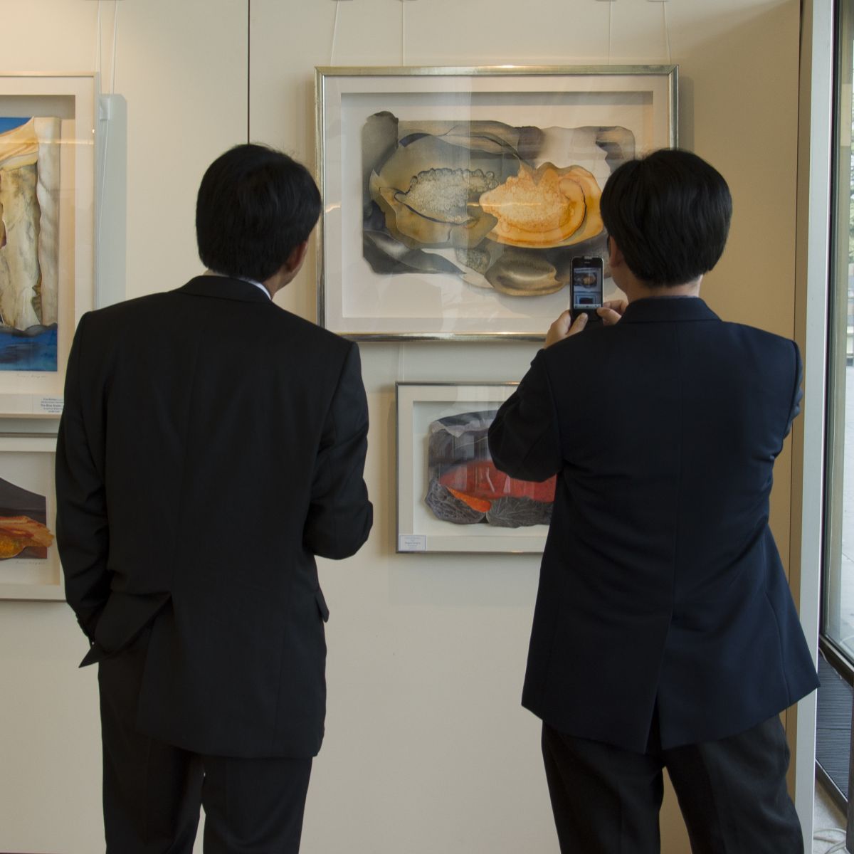 Exhibited paintings behind glass