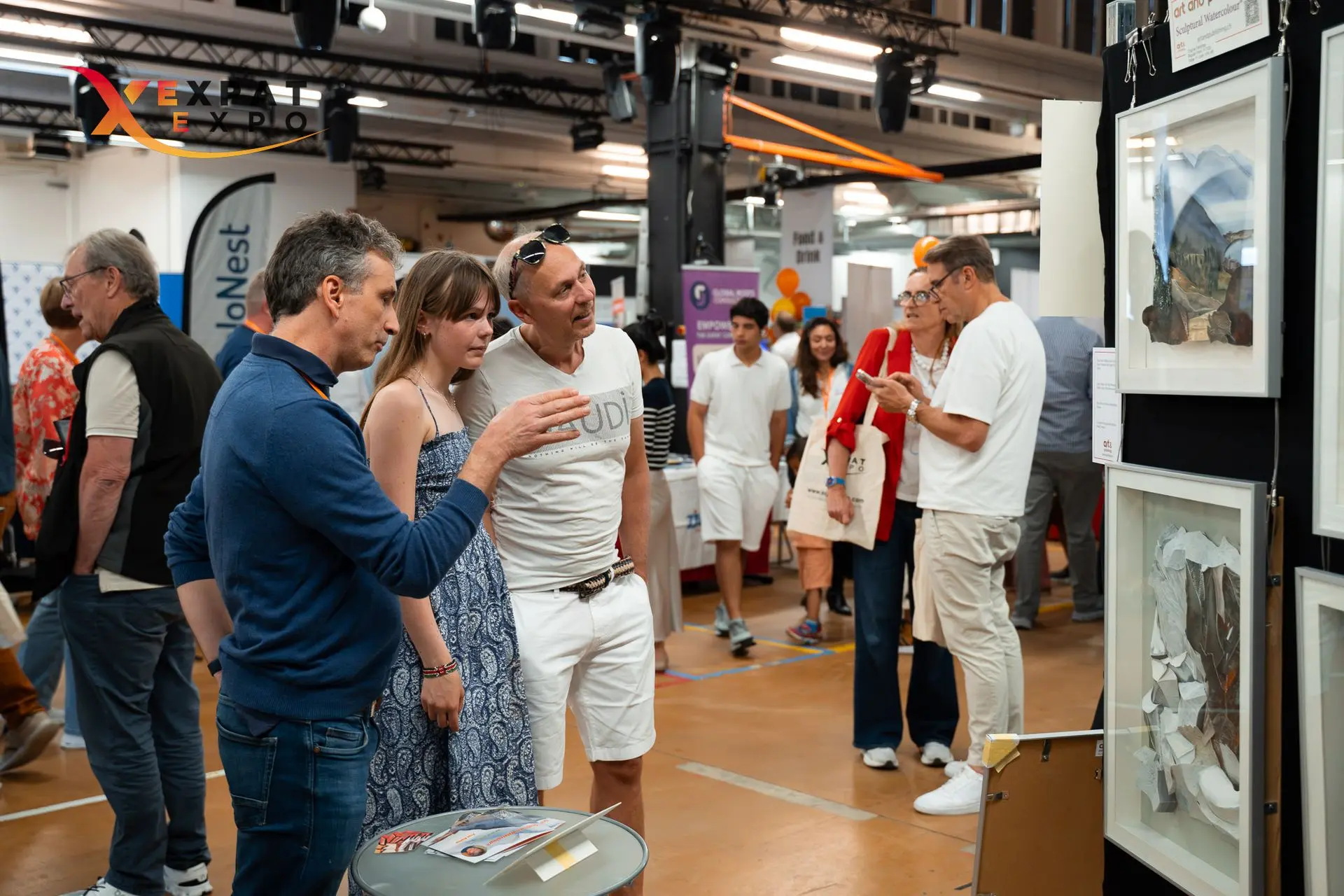 Visitors at the Art & Publishing stand view Sculptural Watercolour® paintings by Prue Bishop
